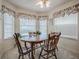 Quaint dining area with large windows providing ample natural light and laminate flooring at 305 Ranchwood Dr, Leesburg, FL 34748