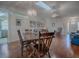 Open living and dining area with hardwood floors, chandelier, and natural light at 305 Ranchwood Dr, Leesburg, FL 34748