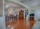 Open living space with laminate flooring connecting the living room, dining area and front entrance at 305 Ranchwood Dr, Leesburg, FL 34748