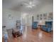 Comfortable living room with hardwood floors, cozy armchairs, and open floor plan at 305 Ranchwood Dr, Leesburg, FL 34748