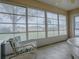 The sun room features large windows offering abundant natural light and exterior views at 305 Ranchwood Dr, Leesburg, FL 34748