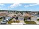 Aerial view showcasing the community featuring well-maintained homes with driveways, lawns, and landscaping at 308 Emmalee Pl, The Villages, FL 32162