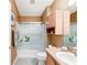 Bathroom featuring a shower-tub combo, mirrored wall, and a sink with a countertop at 308 Emmalee Pl, The Villages, FL 32162