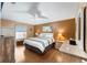 Serene main bedroom with neutral tones, natural light, and plenty of dresser storage at 308 Emmalee Pl, The Villages, FL 32162