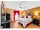 Bedroom featuring a ceiling fan, wood floors, and warm and neutral colors at 308 Emmalee Pl, The Villages, FL 32162