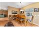 Cozy dining area with wood table set, decor, and natural light from the window at 308 Emmalee Pl, The Villages, FL 32162