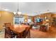 Open-concept living room and dining area featuring a ceiling fan and sliding door to the outside at 308 Emmalee Pl, The Villages, FL 32162