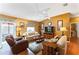 Comfortable living room with neutral-toned furniture, wood floors, and bright natural light at 308 Emmalee Pl, The Villages, FL 32162