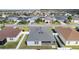 Backyard aerial view showing roof and fenced yard in community at 3356 Blaise Ter, The Villages, FL 32163