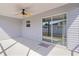 Covered back porch with ceiling fan and sliding glass doors at 3356 Blaise Ter, The Villages, FL 32163