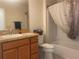 Bathroom featuring a single sink vanity, a toilet, and a shower with a patterned curtain at 3356 Blaise Ter, The Villages, FL 32163