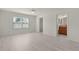 A bedroom featuring light gray wood-look floors, ceiling fan, and a window to let in natural light at 3356 Blaise Ter, The Villages, FL 32163