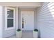 Well-maintained exterior with a white front door and decorative potted plants at 3356 Blaise Ter, The Villages, FL 32163