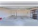 Spacious and clean garage with ample storage space, shelving, and multiple doors at 3356 Blaise Ter, The Villages, FL 32163