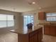 Bright kitchen featuring an island and a sliding glass door to the outdoor area at 3356 Blaise Ter, The Villages, FL 32163