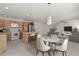 Open kitchen and dining area showcasing wood cabinets, a breakfast bar, and modern appliances at 3356 Blaise Ter, The Villages, FL 32163