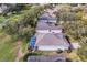 Aerial view of a residential home with screened-in pool, landscaping, and golf course at 3782 Avon Ct, Clermont, FL 34711