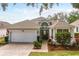 Charming single-story home with a well-manicured lawn and inviting brick pathway to the front door at 3782 Avon Ct, Clermont, FL 34711