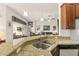 Kitchen sink and granite countertop with stainless steel dishwasher and view into living room at 3782 Avon Ct, Clermont, FL 34711