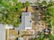 An aerial view of a home with a gray roof, showcasing its layout and the surrounding landscape at 3901 Woodglade Cv, Winter Park, FL 32792