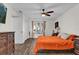 Bedroom featuring a ceiling fan, orange bedspread, and natural lighting at 3901 Woodglade Cv, Winter Park, FL 32792