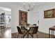 Bright dining area featuring a round glass table, stylish lighting, and unique wall art at 3901 Woodglade Cv, Winter Park, FL 32792