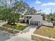 Charming two-story home with a well-maintained lawn and a spacious driveway leading to a two-car garage at 3901 Woodglade Cv, Winter Park, FL 32792