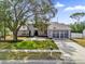 Charming two-story home with a well-maintained lawn and a spacious driveway leading to a two-car garage at 3901 Woodglade Cv, Winter Park, FL 32792