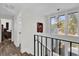 Bright hallway with stylish chandelier and large windows offering scenic views of the surrounding landscape at 3901 Woodglade Cv, Winter Park, FL 32792