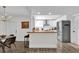 Open-concept kitchen and dining area with stainless steel appliances and butcher block countertops at 3901 Woodglade Cv, Winter Park, FL 32792