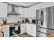 Modern kitchen with stainless steel appliances, subway tile backsplash, and butcher block counters at 3901 Woodglade Cv, Winter Park, FL 32792