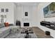 Modern living room showcasing a white brick fireplace and a wall-mounted TV at 3901 Woodglade Cv, Winter Park, FL 32792