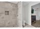 Modern tiled shower with rainfall shower head and decorative accent tiling at 3901 Woodglade Cv, Winter Park, FL 32792