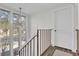 Staircase featuring hardwood steps, natural light, and an updated light fixture at 3901 Woodglade Cv, Winter Park, FL 32792