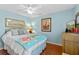 Bedroom with wood floors, a ceiling fan, light blue walls, and wall art at 39131 Griffin Lndg, Lady Lake, FL 32159