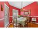 Formal dining room with hardwood floors, wainscoting, chandelier, and plenty of natural light at 39131 Griffin Lndg, Lady Lake, FL 32159