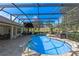 Sparkling pool within a screened enclosure and clear blue skies at 39131 Griffin Lndg, Lady Lake, FL 32159