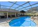 Sparkling pool within a screened enclosure, surrounded by brick patio at 39131 Griffin Lndg, Lady Lake, FL 32159