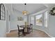 Bright dining room with a bay window, contemporary light fixture and table with four chairs at 406 Bramble Way, Minneola, FL 34715