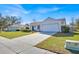 An inviting single-story home with lush front lawn, long driveway and attached two car garage at 406 Bramble Way, Minneola, FL 34715