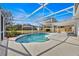 Screened-in pool with a unique design and plenty of space for lounging and entertaining in a private backyard setting at 406 Bramble Way, Minneola, FL 34715