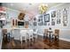 Entertaining bar area featuring a unique chandelier, custom cabinets and hardwood floors at 415 Carman Dr, Leesburg, FL 34748