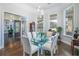 Bright dining room featuring a glass table, backyard views and hardwood floors at 415 Carman Dr, Leesburg, FL 34748