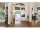 Bright foyer featuring dark wood flooring, an open doorway to screened in porch, and backyard views at 415 Carman Dr, Leesburg, FL 34748