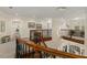 Hallway featuring a decorative stairway, wrought iron railings and a stunning chandelier at 415 Carman Dr, Leesburg, FL 34748