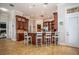 Expansive kitchen island with bar seating and granite countertops, ideal for casual dining and entertaining guests at 415 Carman Dr, Leesburg, FL 34748