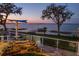 Breathtaking waterfront view featuring patio seating with an umbrella for shade overlooking the water at 415 Carman Dr, Leesburg, FL 34748