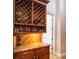 Custom wine bar with diamond storage, granite countertops, and glass rack for a luxurious and sophisticated entertaining space at 415 Carman Dr, Leesburg, FL 34748