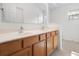 Bathroom with double sink vanity, wood cabinets, and ample counter space at 464 Dominish Estates Dr, Apopka, FL 32712