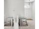 Modern dining room with a glass table and chairs set on neutral carpet with double door entrance at 464 Dominish Estates Dr, Apopka, FL 32712